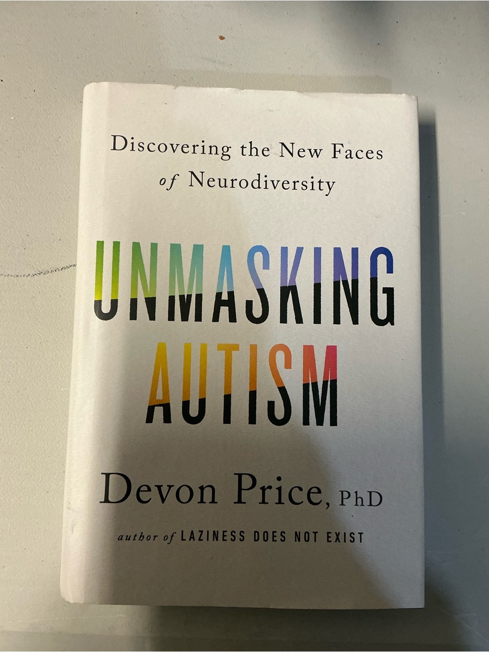 Unmasking Autism by Devon Price, PhD - White Cover with Multicolor Title